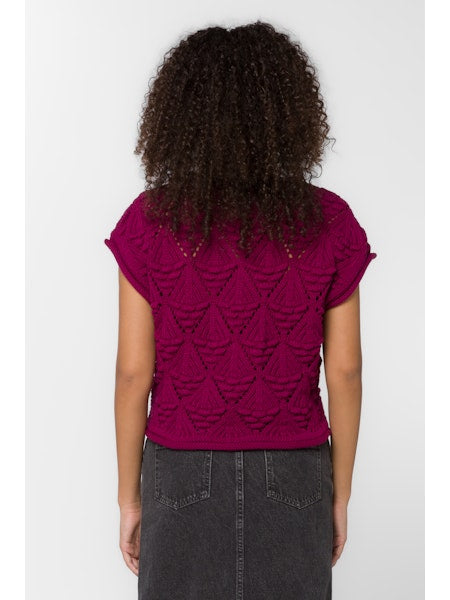 Person wearing a purple top with a textured pattern on a white background