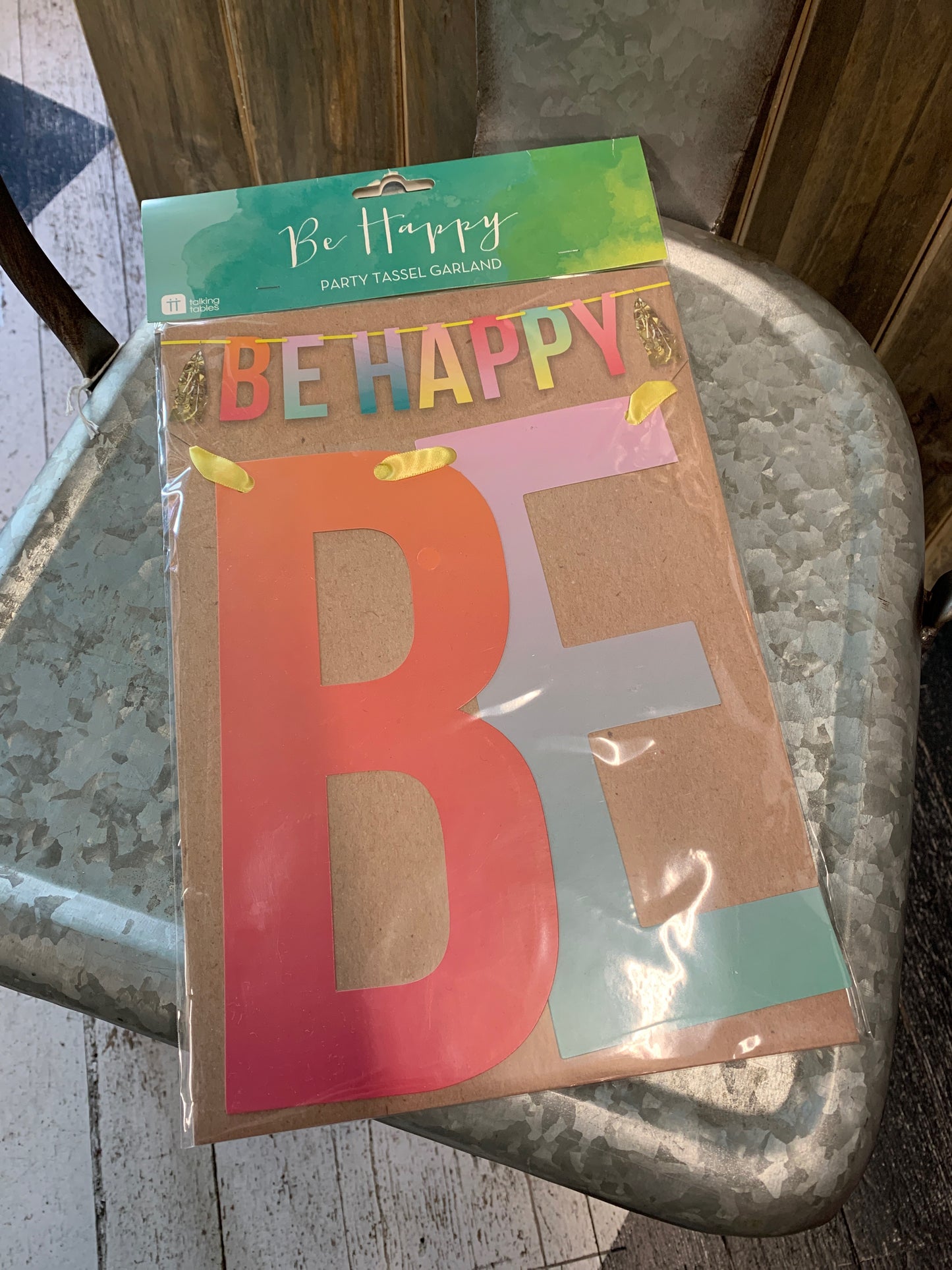 Multi-colored, hombre styled, party tasseled garland that spells out "Be Happy".