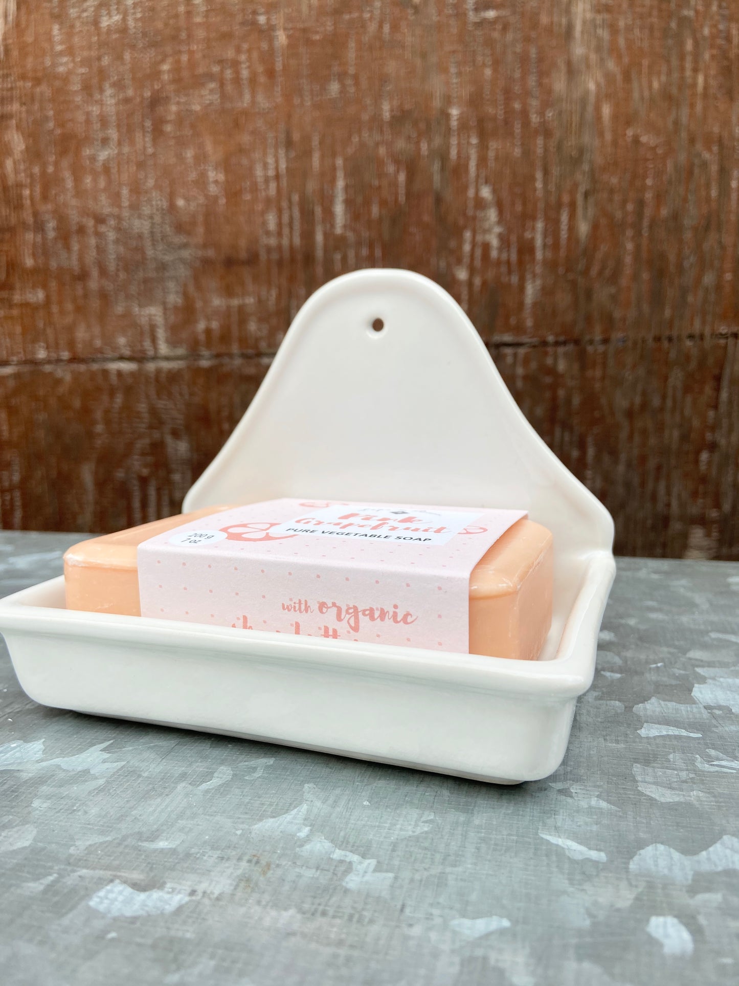 This ivory soap dish can sit on the counter or hang on the wall. It has a small hole near the top that is less than .25" round. Inside dimensions are 4.25"L x 2.5"W x .75"H *soap not included