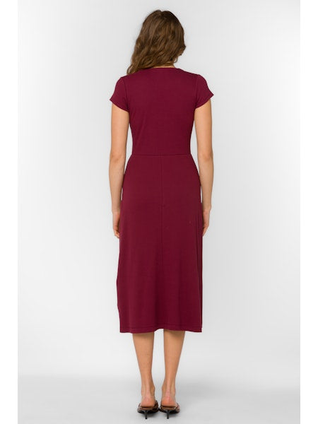 Woman wearing a burgundy dress on a white background