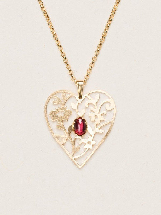 Our Blooming Heart Necklace is a work of tender beauty. The art of metal cutting is gorgeously displayed in this elaborate depiction of emerging springtime foliage, where a dazzling gemstone blooms brightly from the center. 