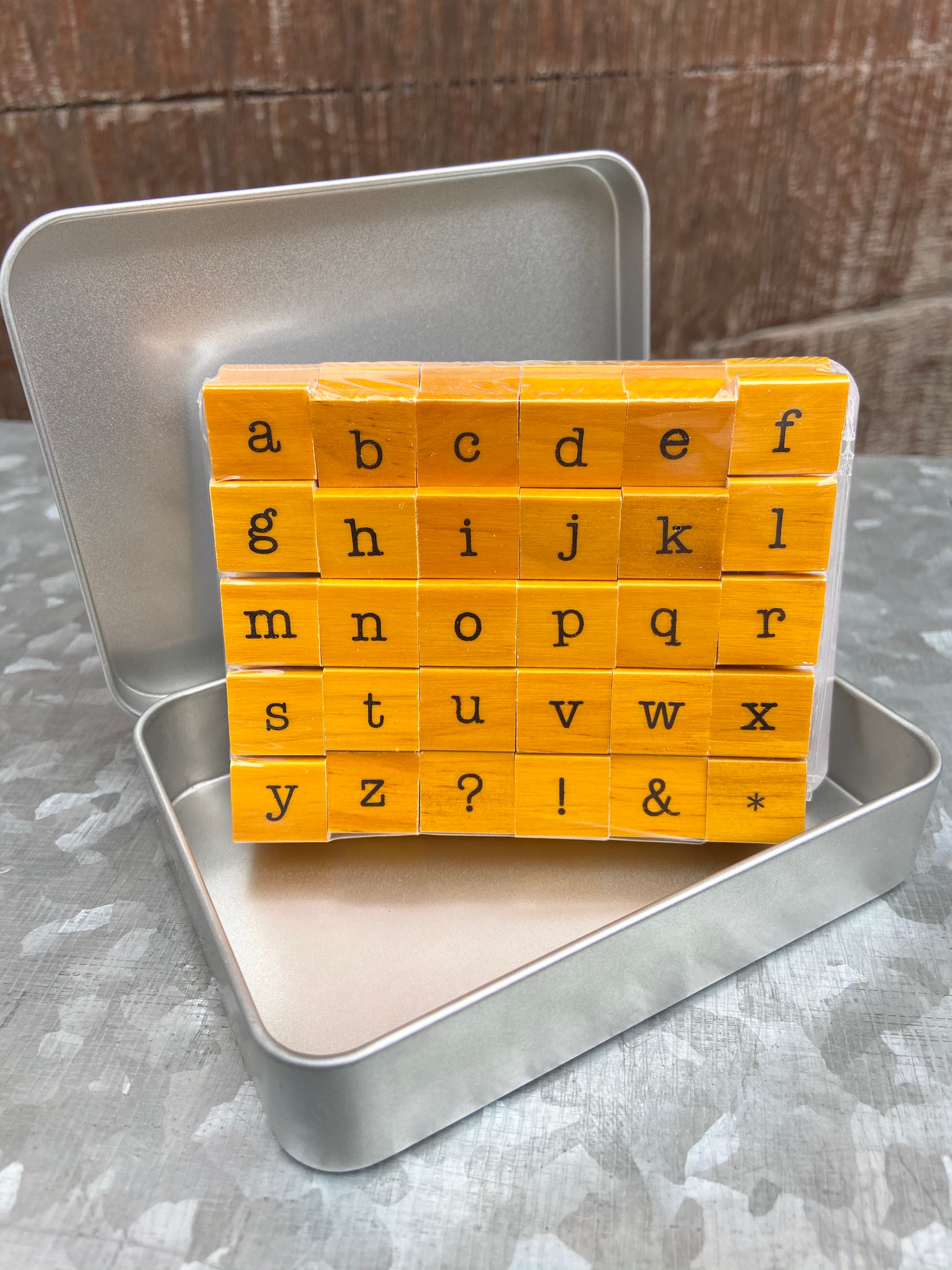 Set of vintage, wooden, rubber stamps. Set includes 26 lowercase alphabet plus 4 punctuation stamps. Stamps are approximately 1/2" square.