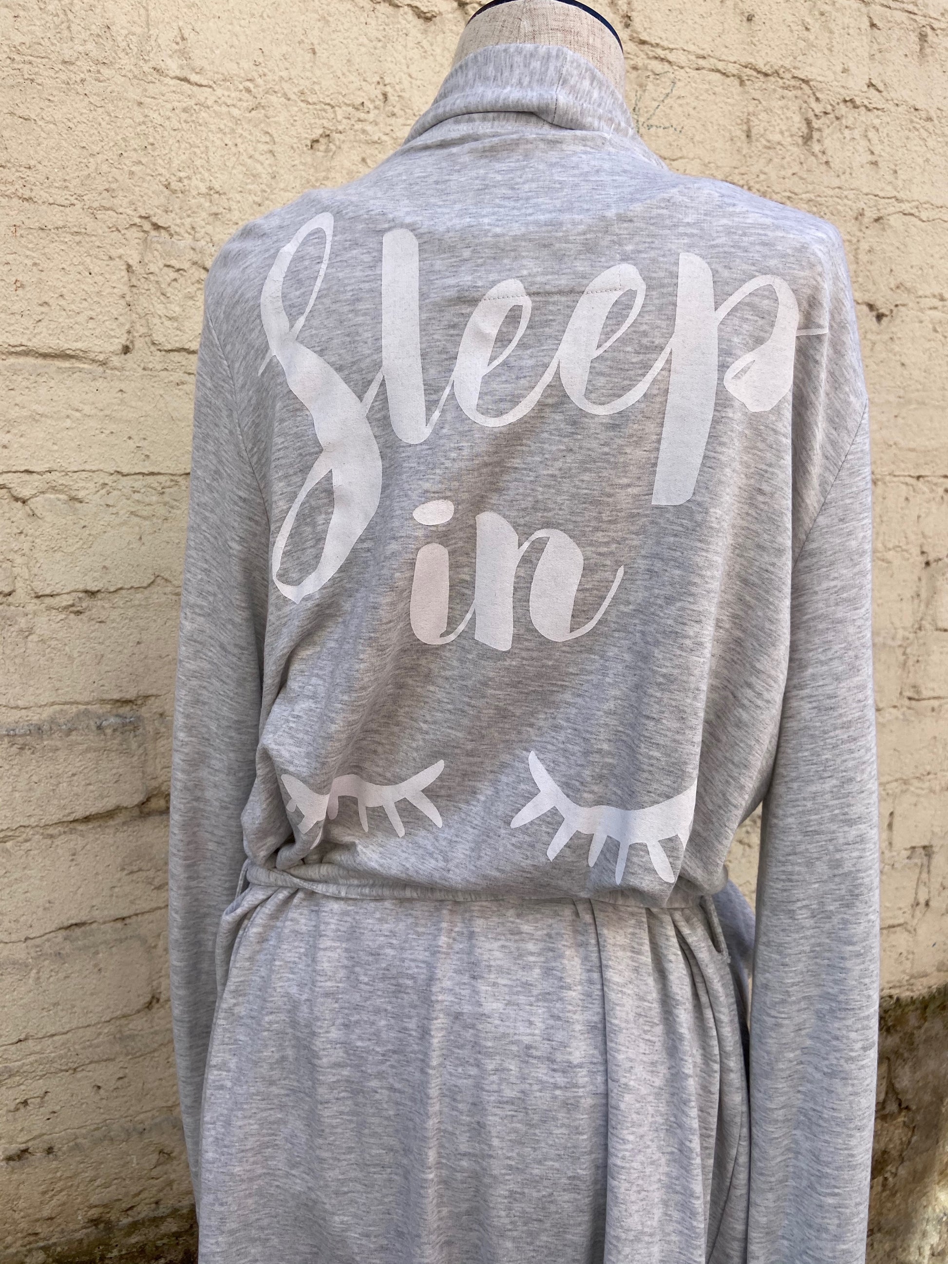 Relaxed fit, pebble grey robe. 95% Modal/5% Spandex. Back of robe has words that read, "Sleep in".