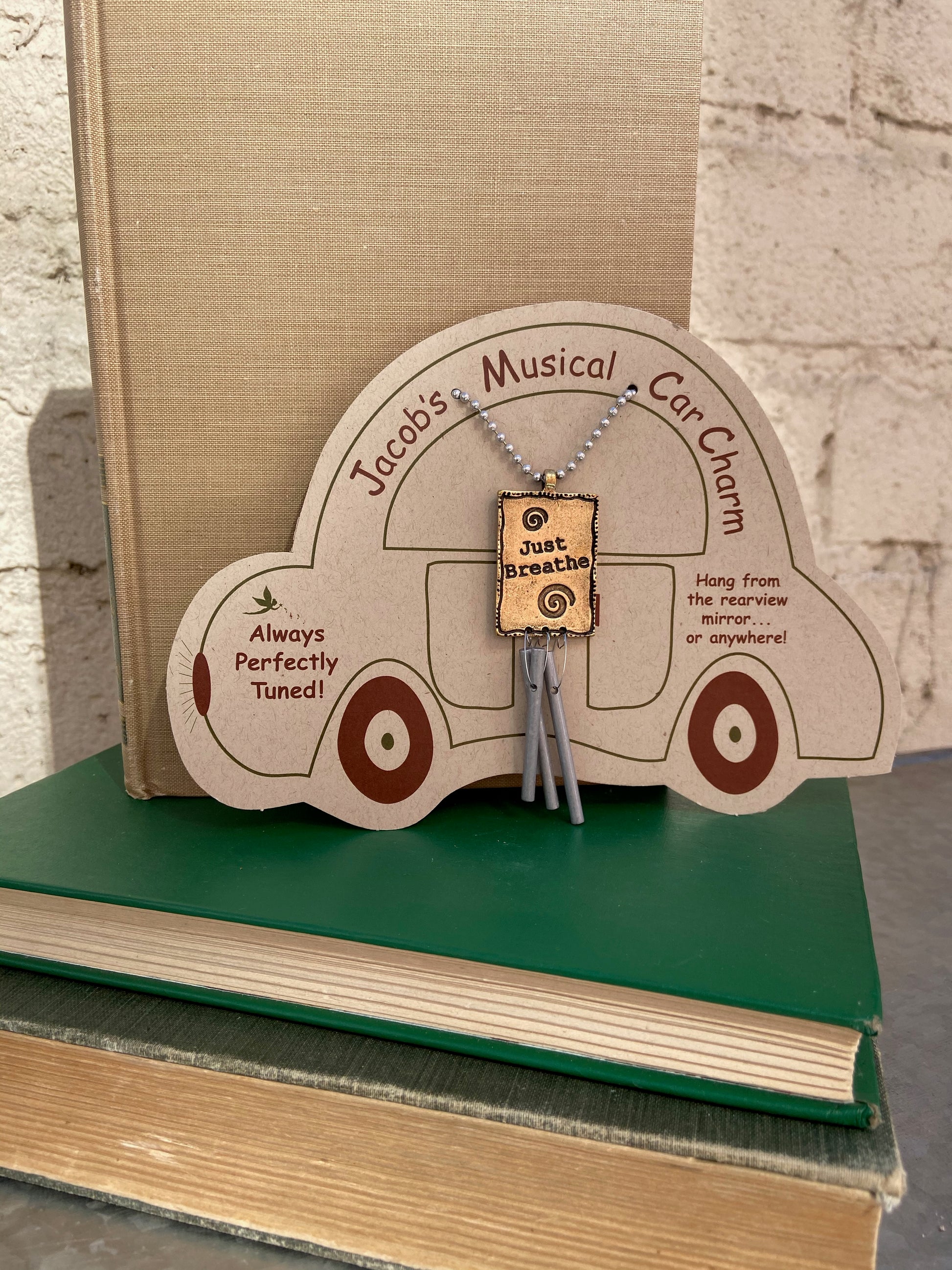 Musical Car Charms will soothe and relax as you navigate the busy highways of life. Cast metal charm is etched on both sides and finished in antique brass. Relaxing and pleasing sound from three perfectly tuned aluminum pipes. Musical instrument and chime maker Jacob Sokoloff hand tunes these car chimes to produce a musical sound guaranteed to make you smile. Dimensions: 3 inches tall plus 9 inch ball chain.