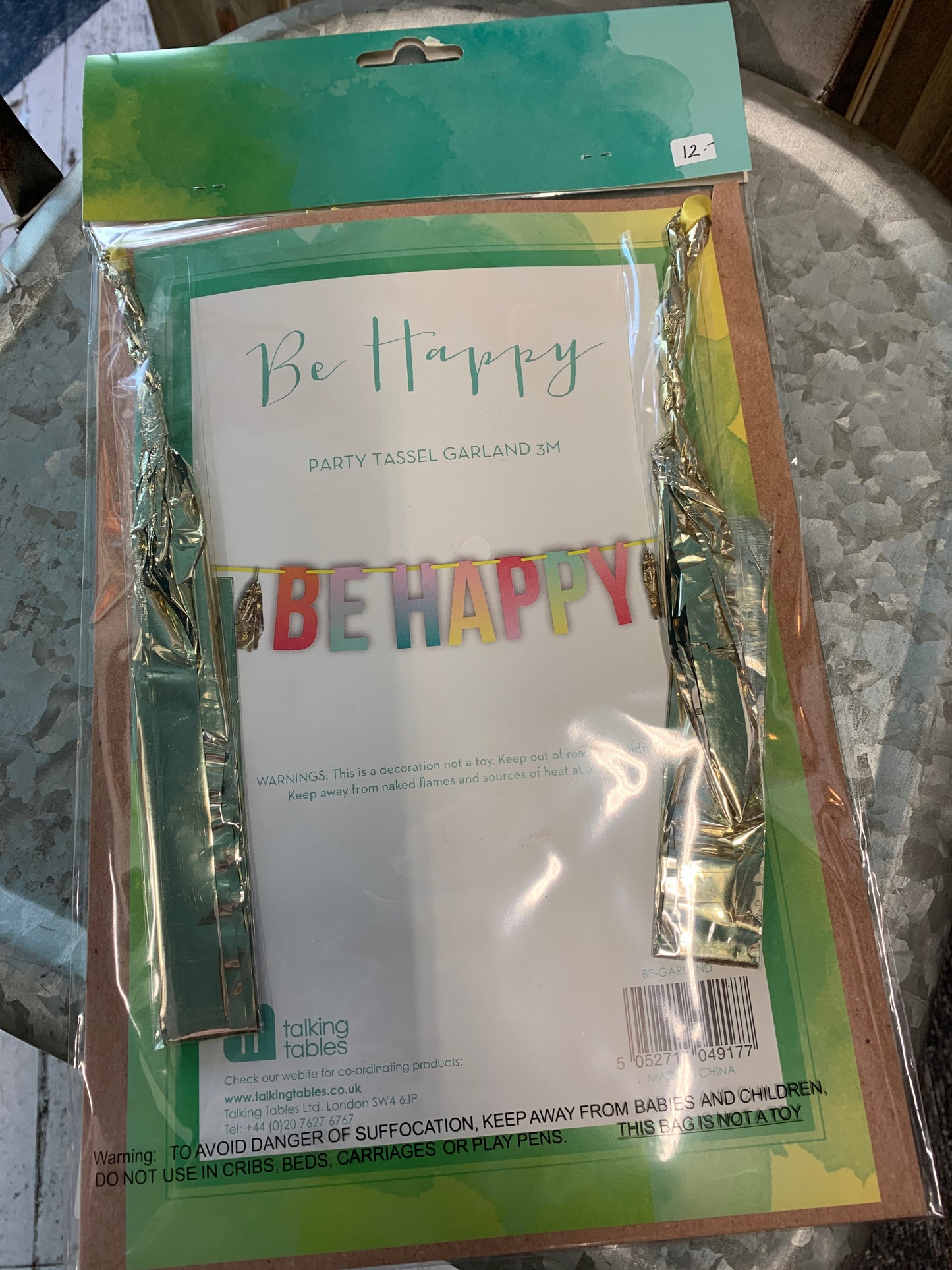 Multi-colored, hombre styled, party tasseled garland that spells out "Be Happy".