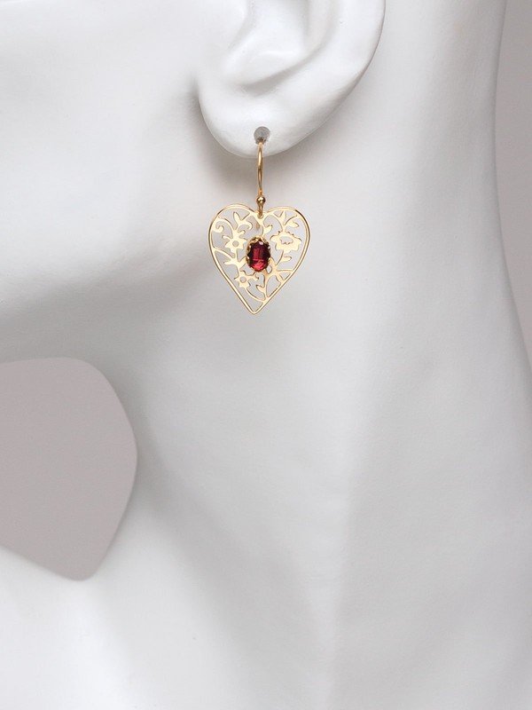Our Blooming Heart Earrings are a work of tender beauty. The art of metal cutting is gorgeously displayed in this elaborate depiction of emerging springtime foliage, where a dazzling gemstone blooms brightly from the center.